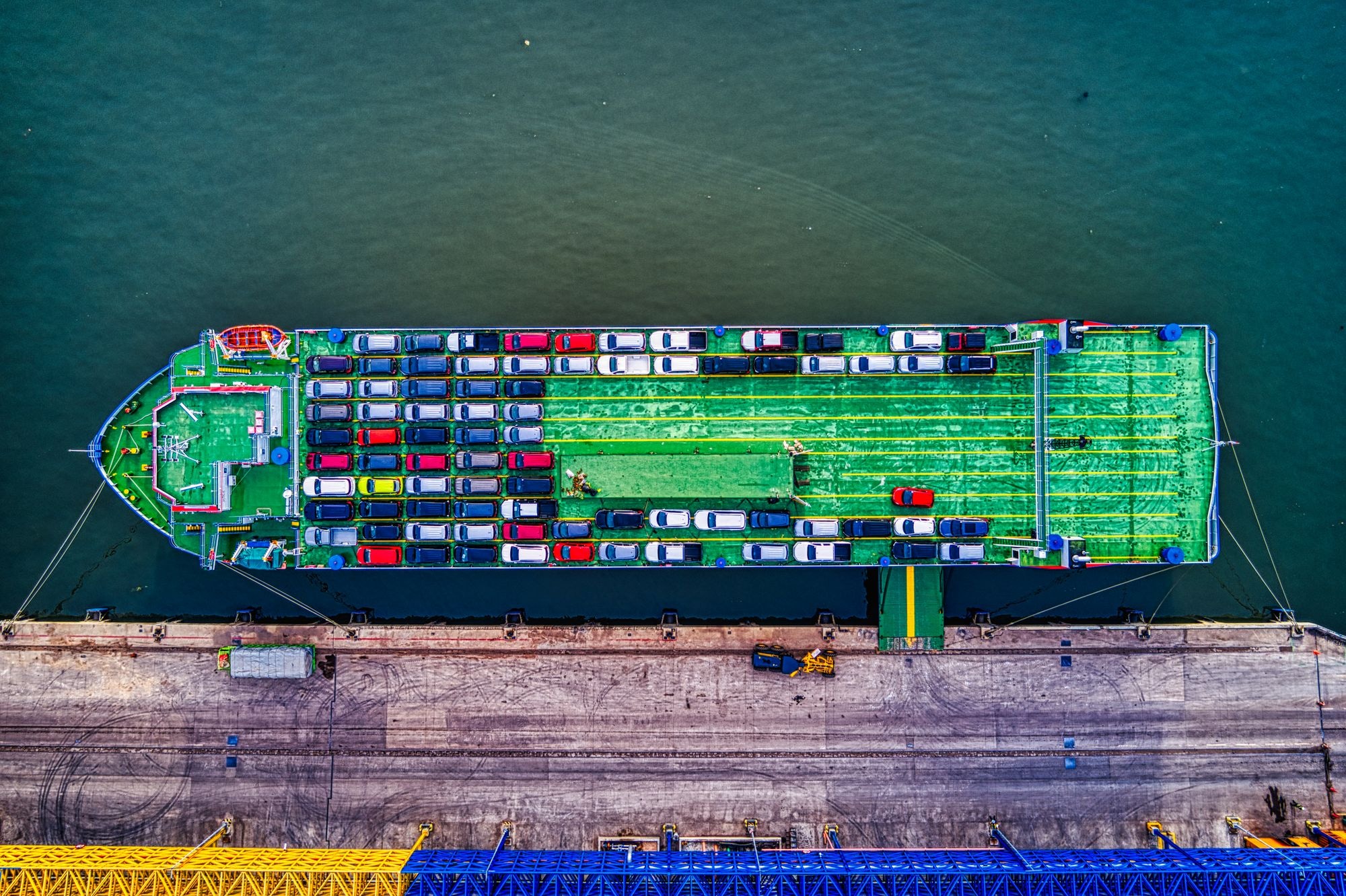 Aerial view of a car transport ship docked at port